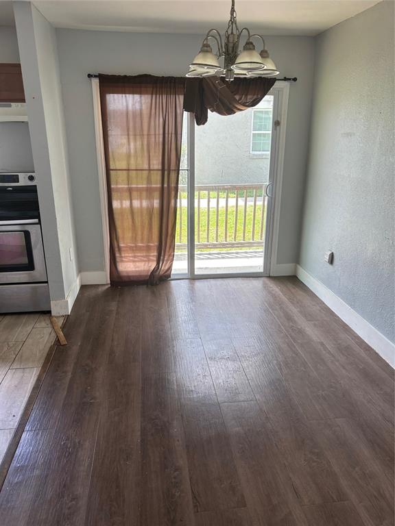 2779 L B McLeod Road, Unit A Orlando, FL 32805 - Photo 3 of 8 an empty room with wooden floor and windows