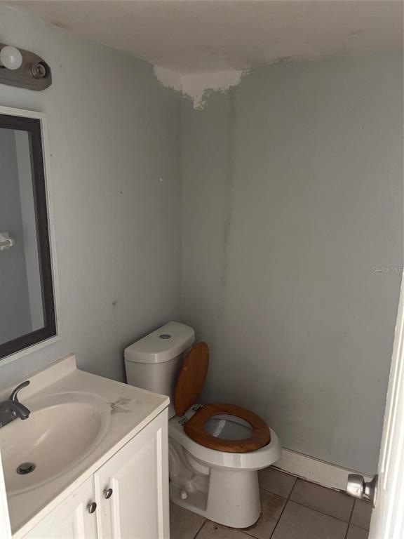 2779 L B McLeod Road, Unit A Orlando, FL 32805 - Photo 6 of 8 a white toilet sitting next to a bathroom sink