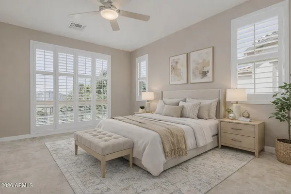 a spacious bedroom with a bed and a couch