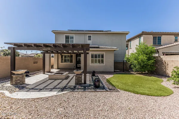 a view of a house with backyard and sitting area