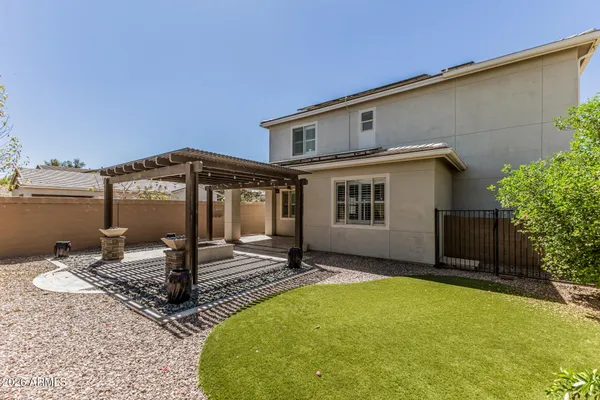 a view of a patio with table and chairs and potted plants
