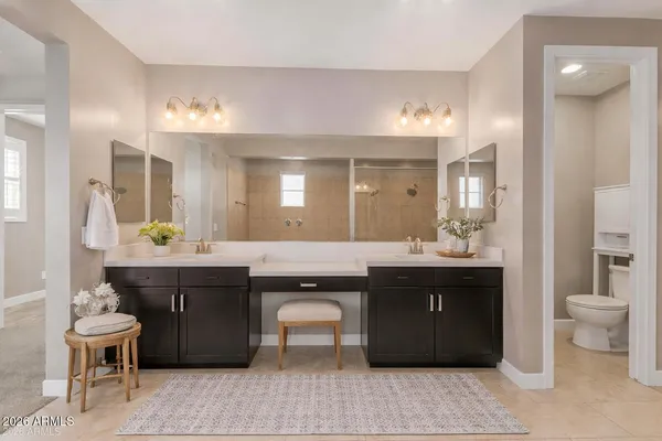 a spacious bathroom with a granite countertop sink a toilet a mirror and bathtub