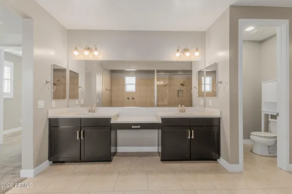 a spacious bathroom with a granite countertop sink and a mirror