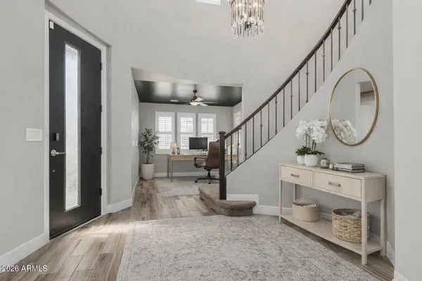 a view of entryway and hall with wooden floor
