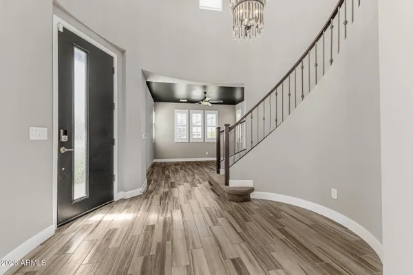 a view of entryway and hall with wooden floor