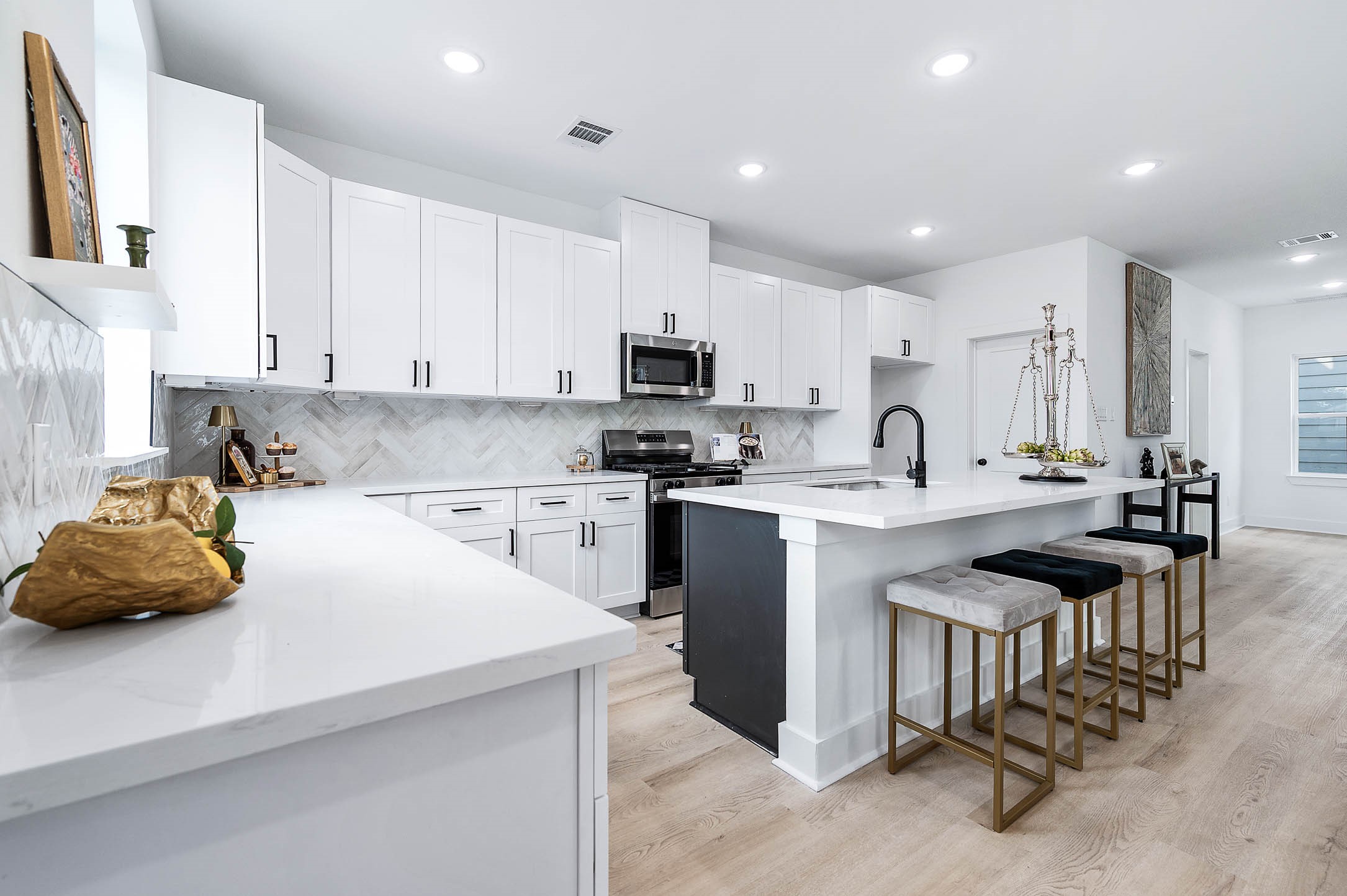 1515 Euel Street Houston, TX 77009 - Photo 14 of 34 Contemporary kitchen with a functional island and modern finishes, offering both style and practicality.