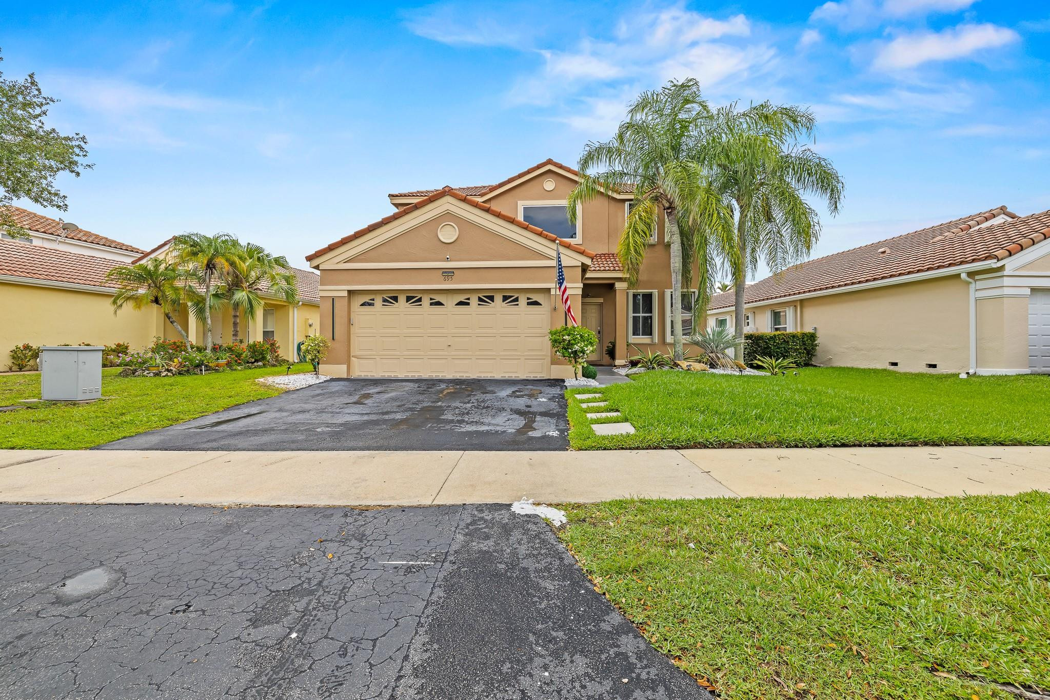 695 Falling Water Road Weston, FL 33326 - Photo 1 of 31 a front view of a house with a yard and garage