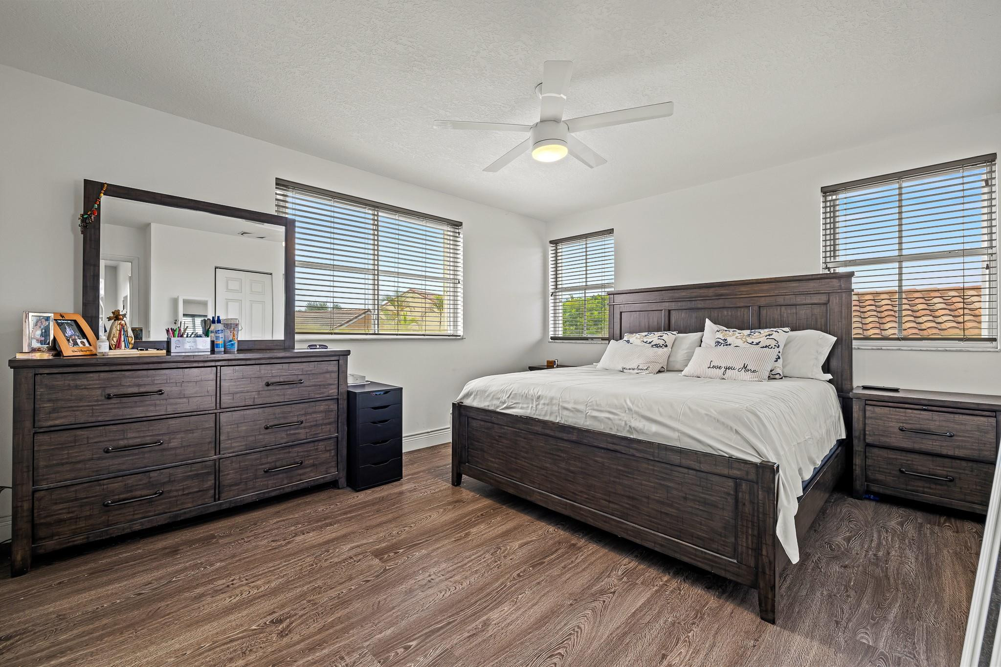 695 Falling Water Road Weston, FL 33326 - Photo 18 of 31 a bedroom with a bed and a dresser