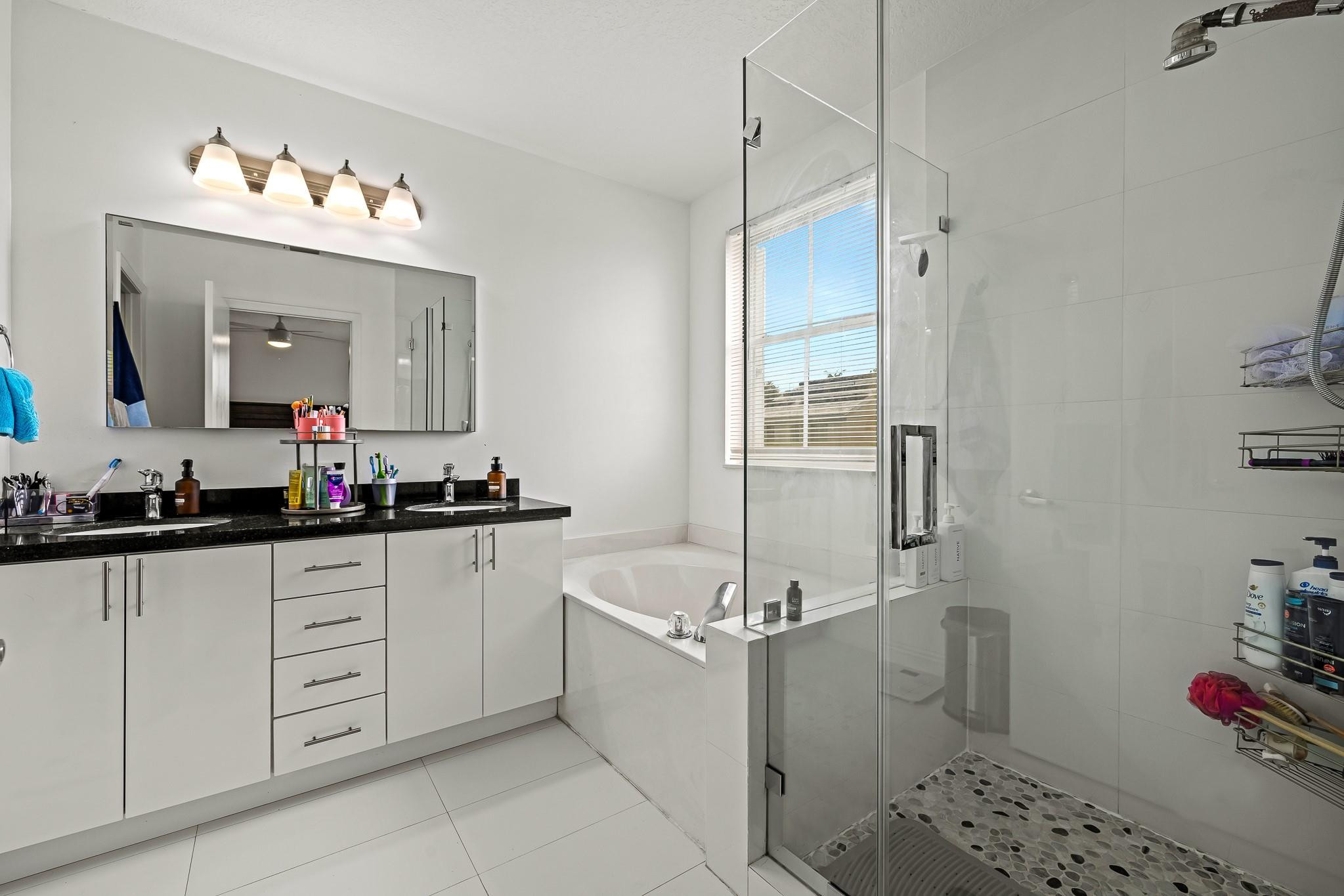 695 Falling Water Road Weston, FL 33326 - Photo 19 of 31 a bathroom with a double vanity sink mirror and toilet