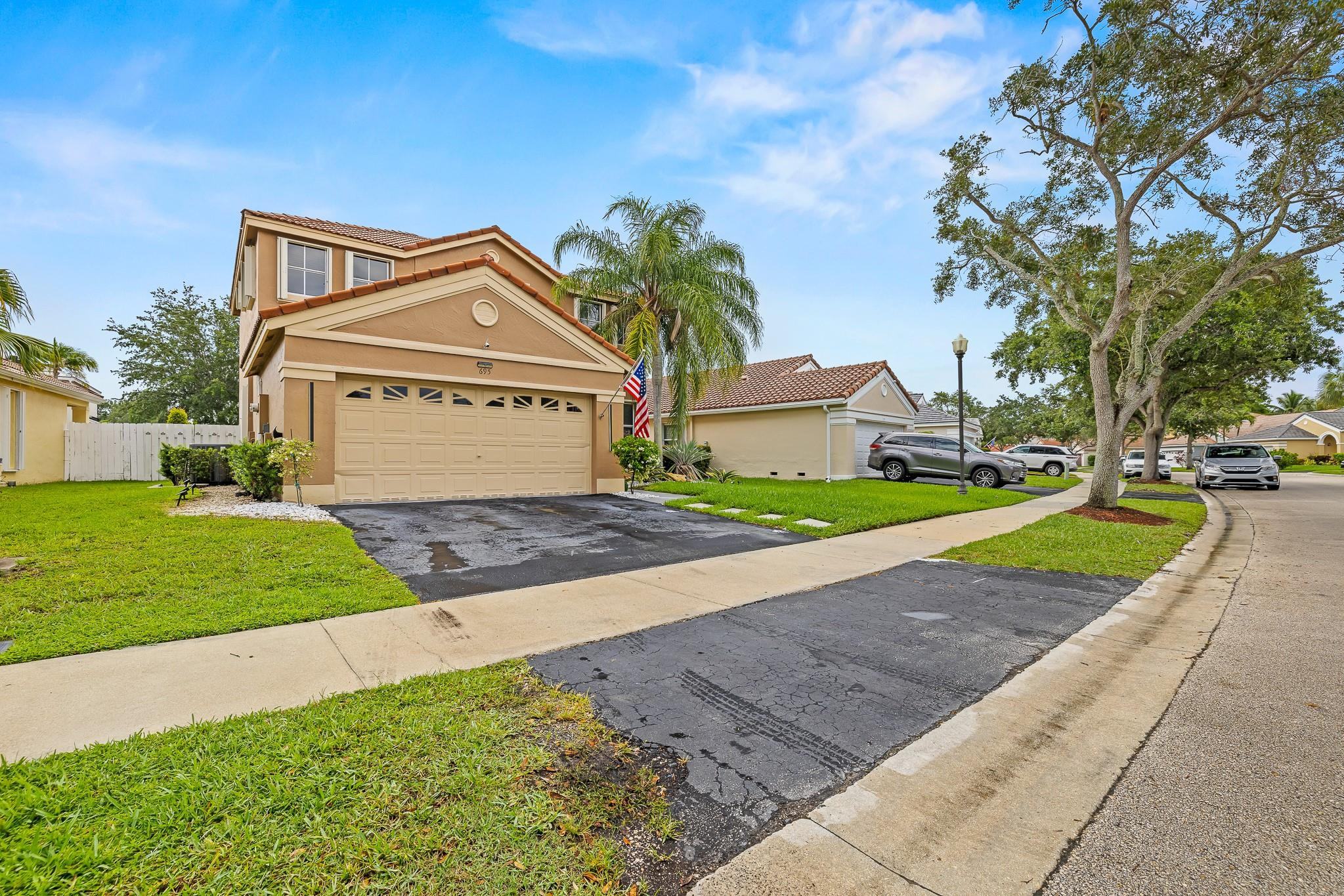 695 Falling Water Road Weston, FL 33326 - Photo 2 of 31 a view of a house with a yard and large trees
