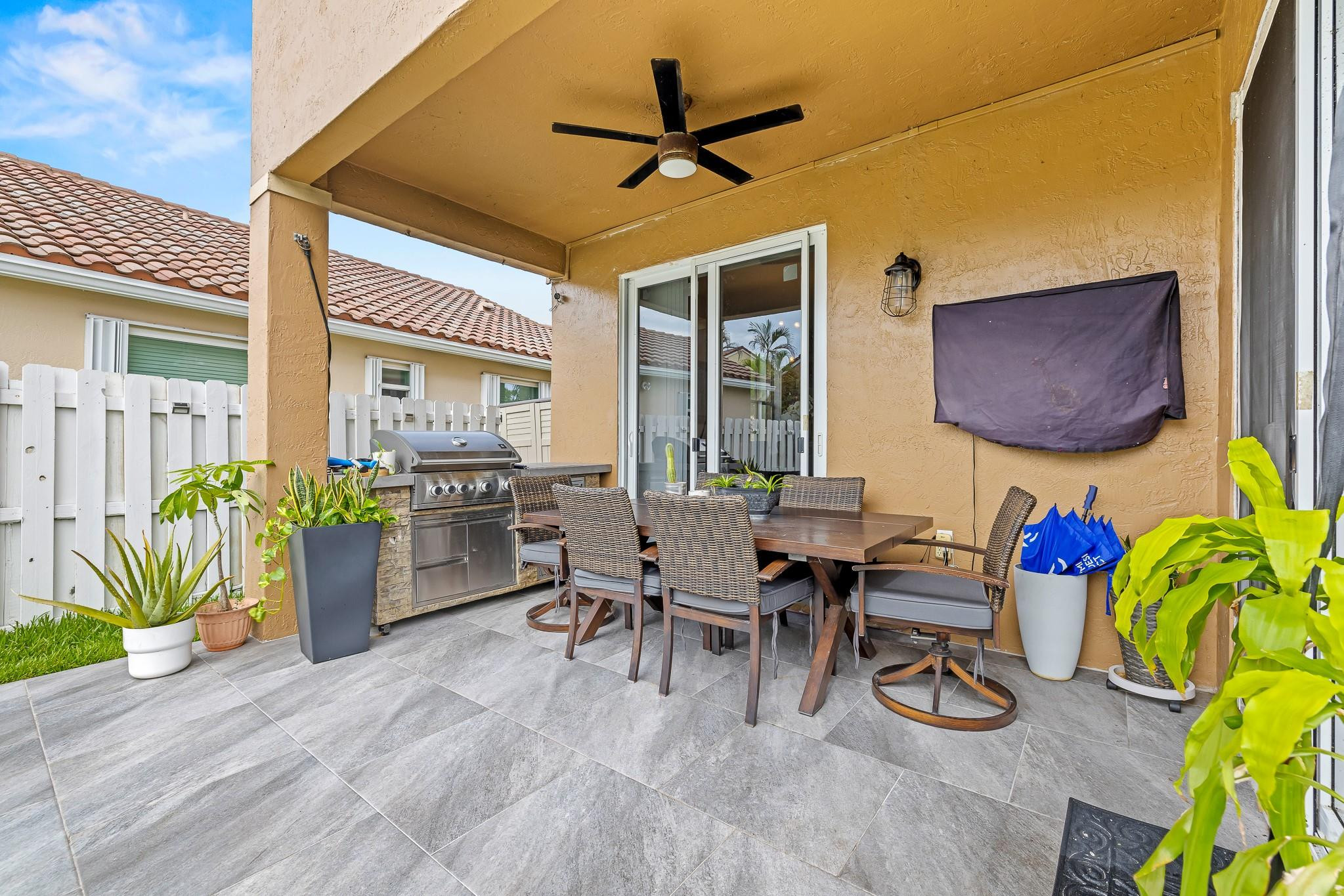695 Falling Water Road Weston, FL 33326 - Photo 22 of 31 a dining room with furniture and a potted plant