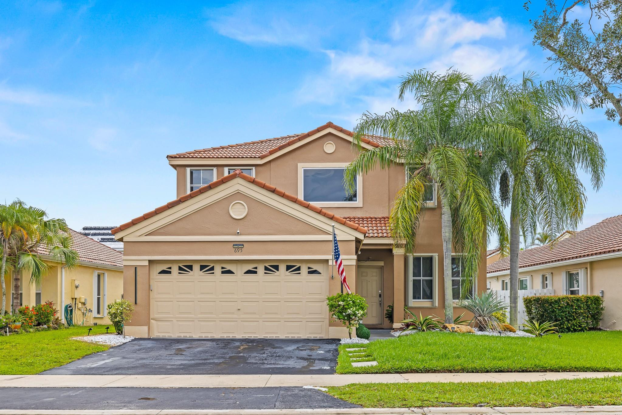 695 Falling Water Road Weston, FL 33326 - Photo 3 of 31 a front view of a house with a yard