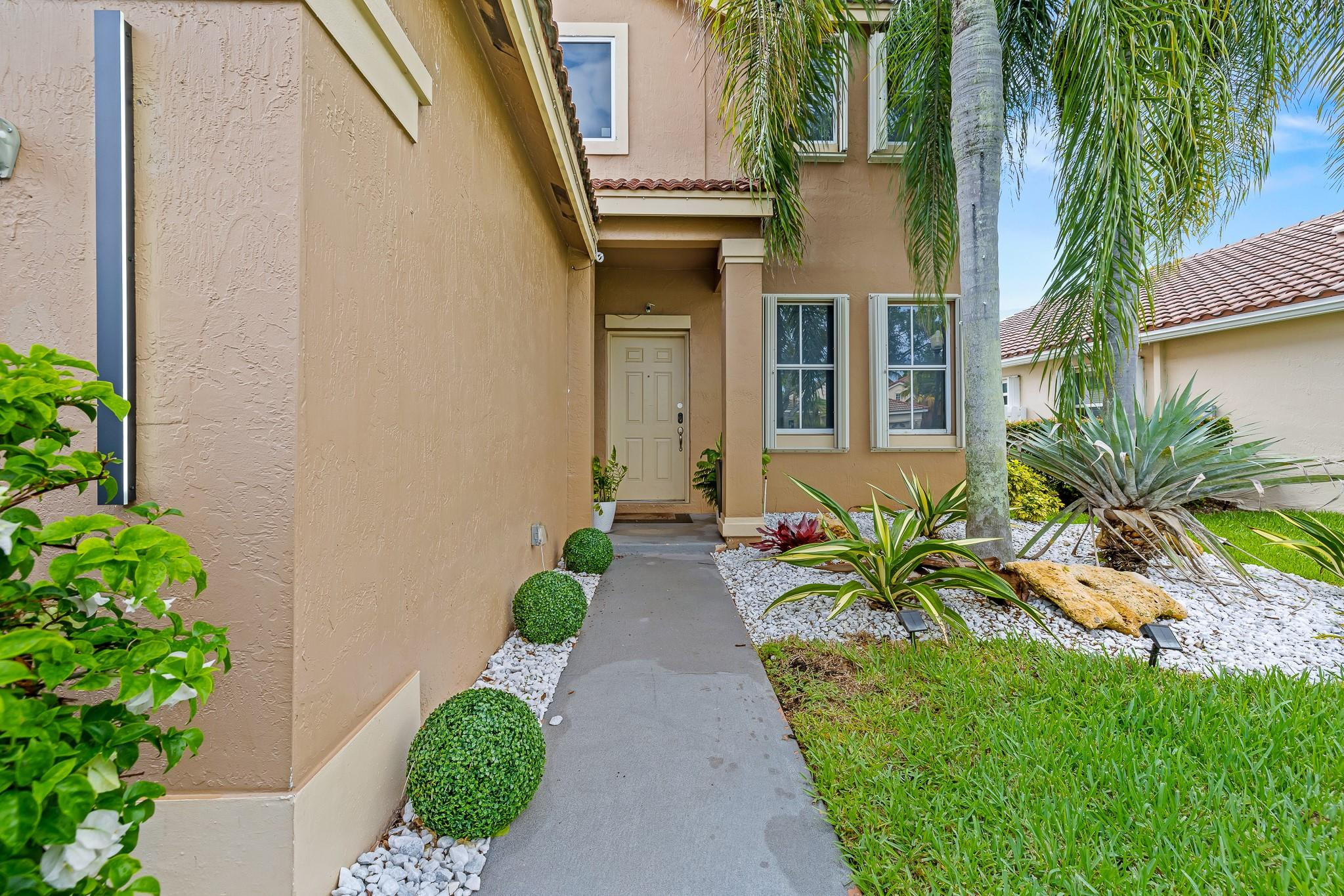 695 Falling Water Road Weston, FL 33326 - Photo 4 of 31 a view of a pathway with a house