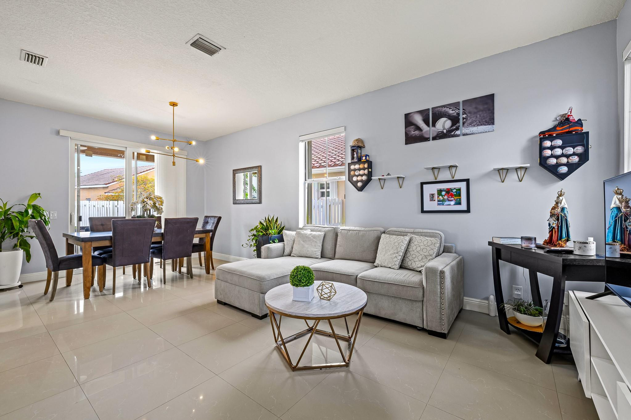 695 Falling Water Road Weston, FL 33326 - Photo 5 of 31 a living room with furniture and a dining table