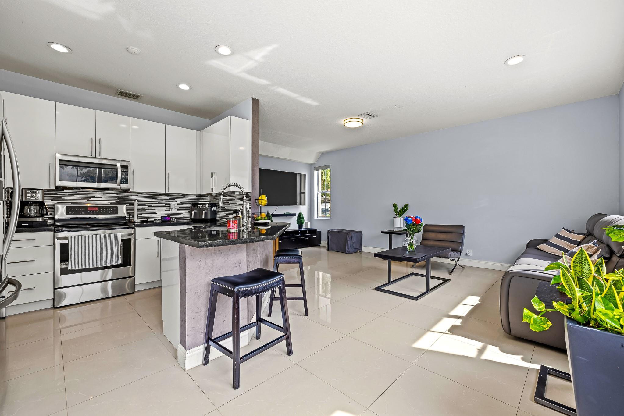 695 Falling Water Road Weston, FL 33326 - Photo 10 of 31 a kitchen with counter top space appliances and cabinets