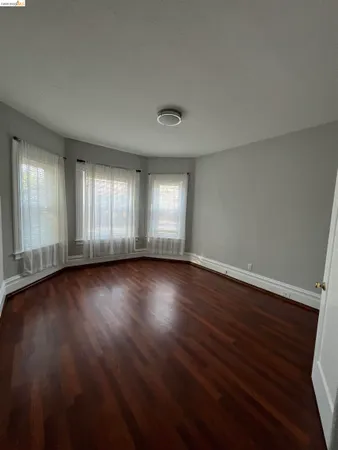 a view of wooden floor and windows in an empty room