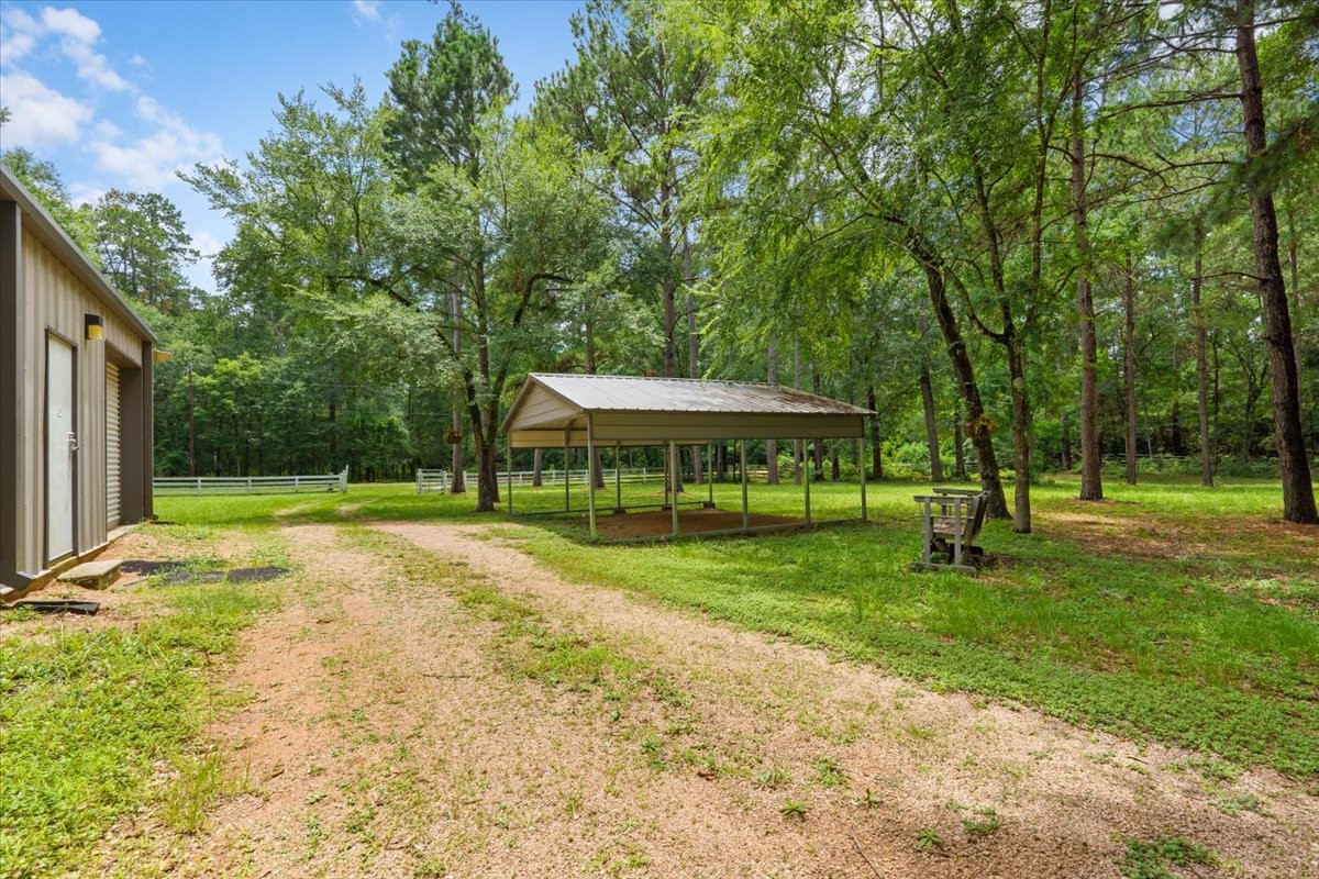 16375 Grand Flower Road Plantersville, TX 77363 - Photo 33 of 50 a view of a house with a yard