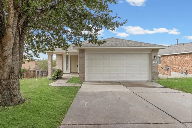 a view of a house with a yard and garage