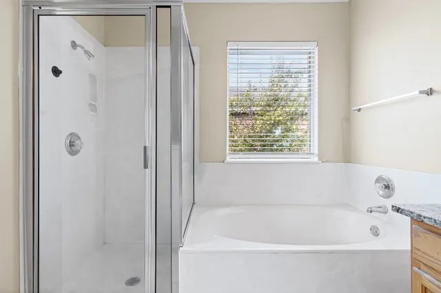 a bathroom with a bathtub and shower