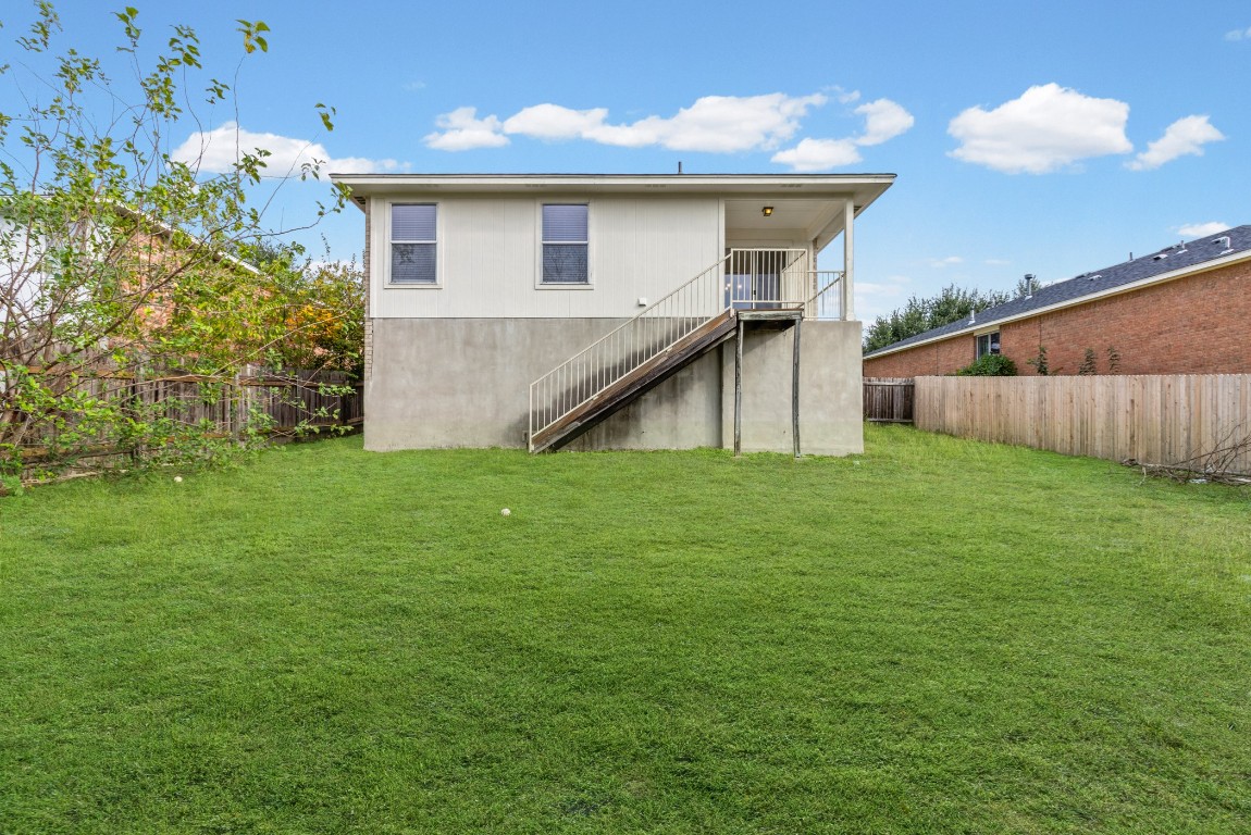 317 Tudor House Road Pflugerville, TX 78660 - Photo 21 of 28 a view of a house with a yard and a tree
