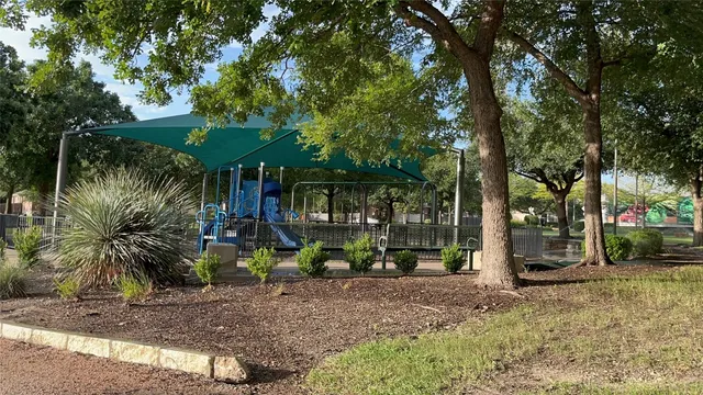 a view of a tree in front of a house