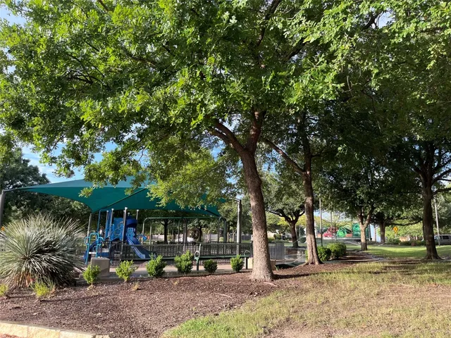 a view of park with tree in front of it