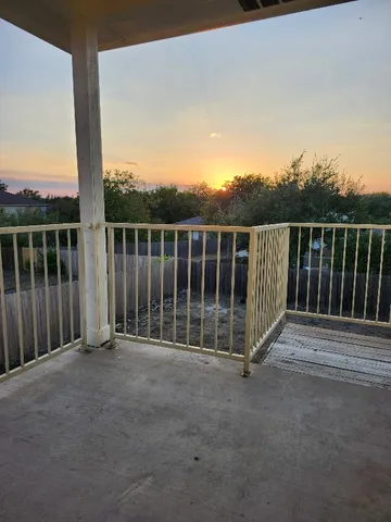 a view of a balcony with a floor to ceiling window