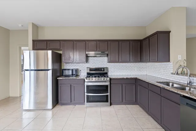 a kitchen with a sink stove and refrigerator