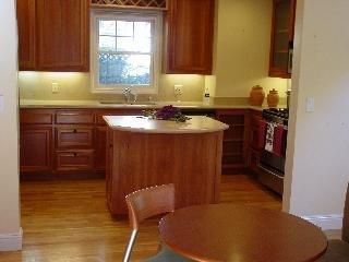 a kitchen with granite countertop a sink cabinets and window