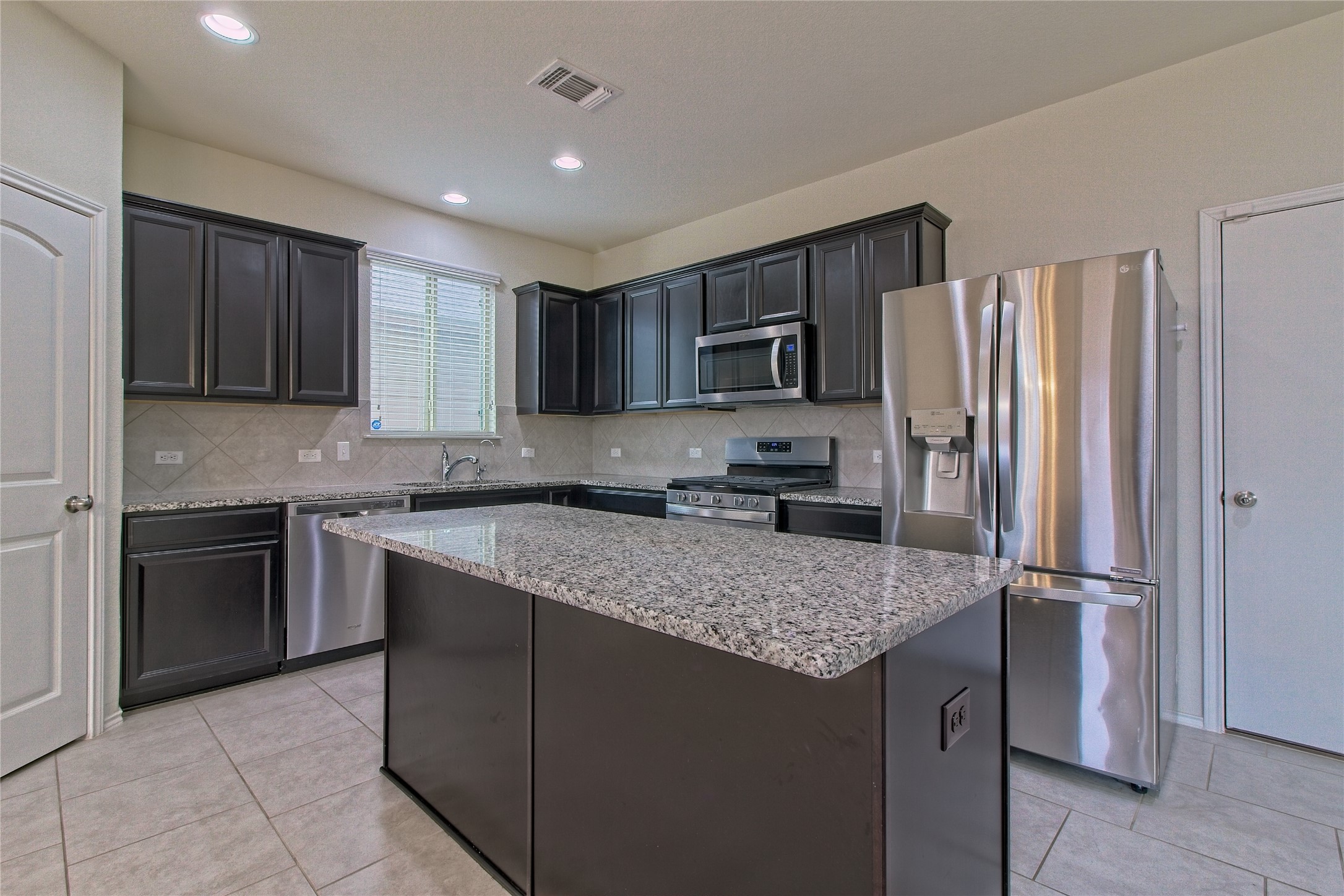 521 Staton Street Georgetown, TX 78626 - Photo 4 of 39 a kitchen with a refrigerator sink and microwave