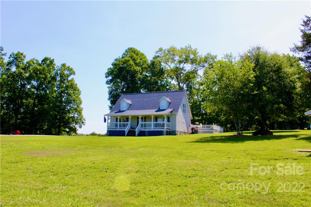 a house view with swimming pool in front of it