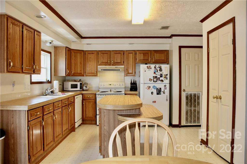 353 Duncan Road Rutherfordton, NC 28139 - Photo 11 of 42 a kitchen with stainless steel appliances granite countertop a refrigerator and a stove top oven