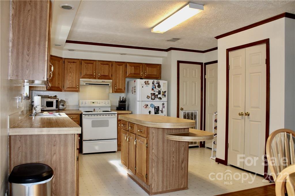 353 Duncan Road Rutherfordton, NC 28139 - Photo 12 of 42 a kitchen with a stove a refrigerator and a sink