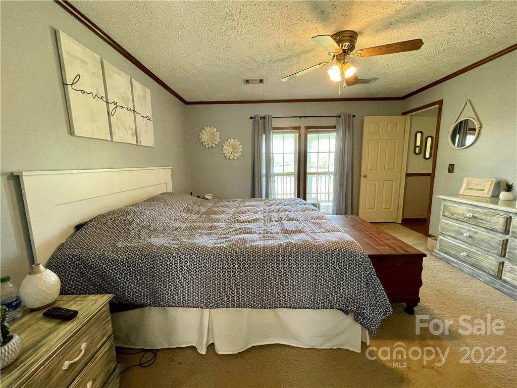 353 Duncan Road Rutherfordton, NC 28139 - Photo 18 of 42 a bedroom with a bed and a chandelier