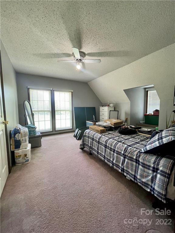 353 Duncan Road Rutherfordton, NC 28139 - Photo 20 of 42 a bedroom with a large bed and a couch