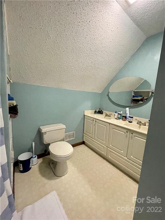 353 Duncan Road Rutherfordton, NC 28139 - Photo 21 of 42 a bathroom with a toilet sink and mirror