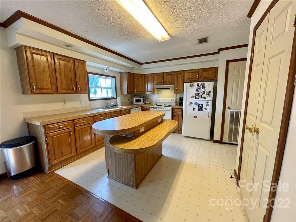 353 Duncan Road Rutherfordton, NC 28139 - Photo 6 of 42 a kitchen with stainless steel appliances granite countertop a sink stove and refrigerator