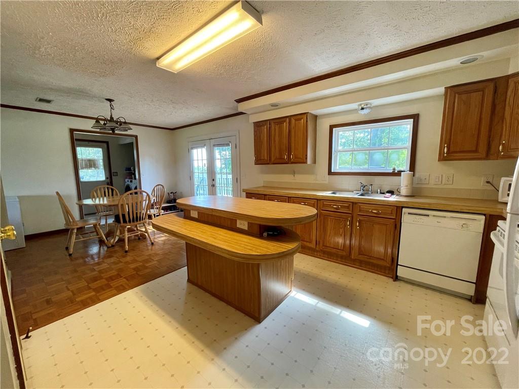 353 Duncan Road Rutherfordton, NC 28139 - Photo 7 of 42 a kitchen with stainless steel appliances granite countertop a sink and a refrigerator