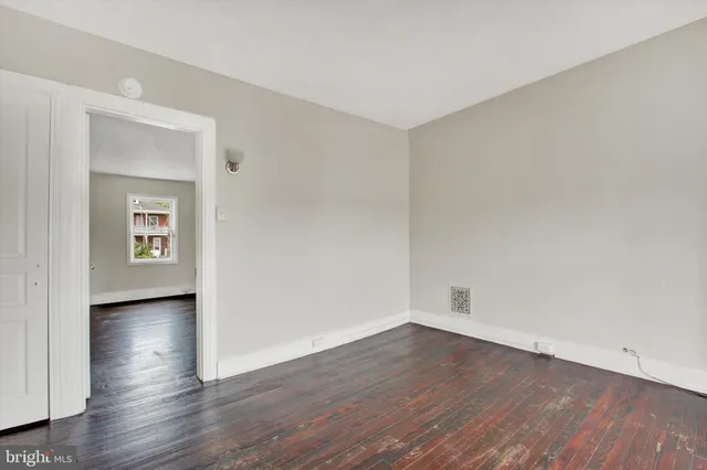 a view of a room with wooden floor and windows