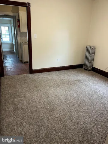 a view of an empty room and wooden floor