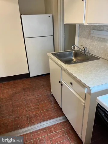a kitchen with a sink and a refrigerator