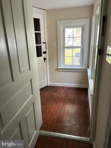 a view of an entryway with wooden floor