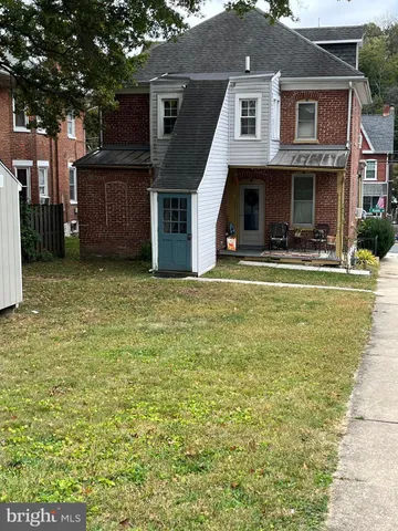 a view of house with outdoor space and swimming pool