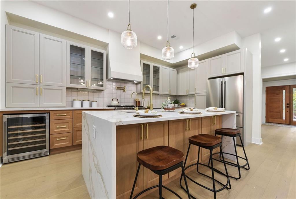 919 Heberton Street Pittsburgh, PA 15206 - Photo 21 of 49 a kitchen with kitchen island granite countertop a sink a center island and cabinets