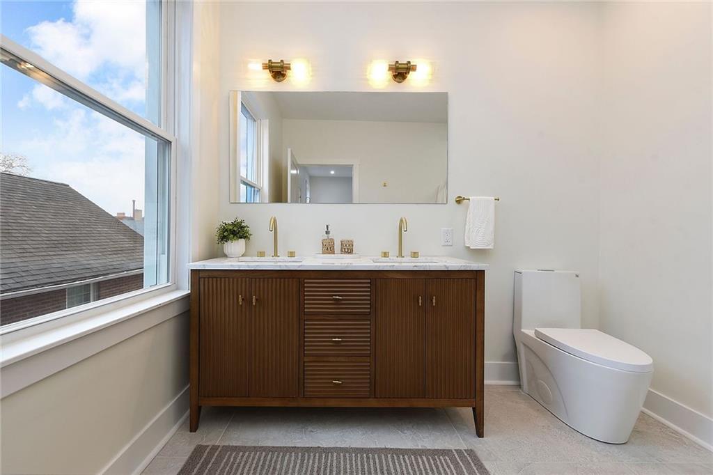 919 Heberton Street Pittsburgh, PA 15206 - Photo 32 of 49 a bathroom with a granite countertop sink and a mirror