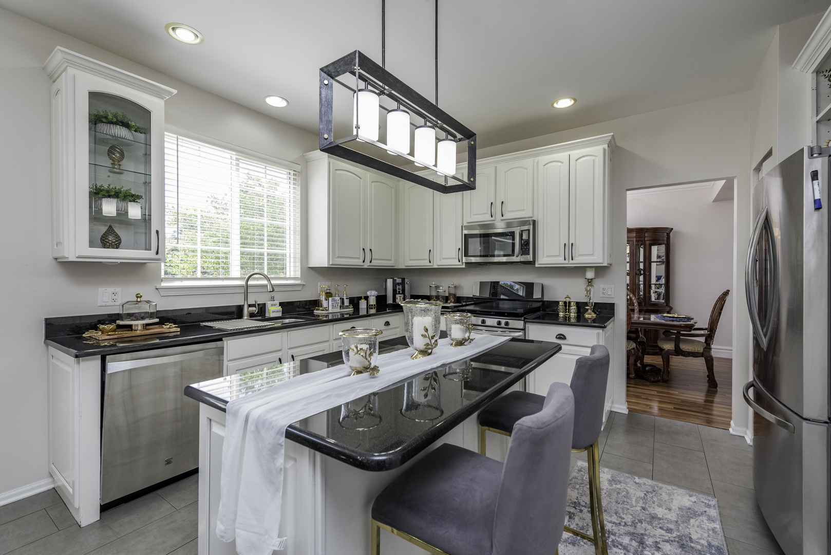 1650 Natures Way Lindenhurst, IL 60046 - Photo 14 of 55 a kitchen with a stove a sink a refrigerator and a dining table