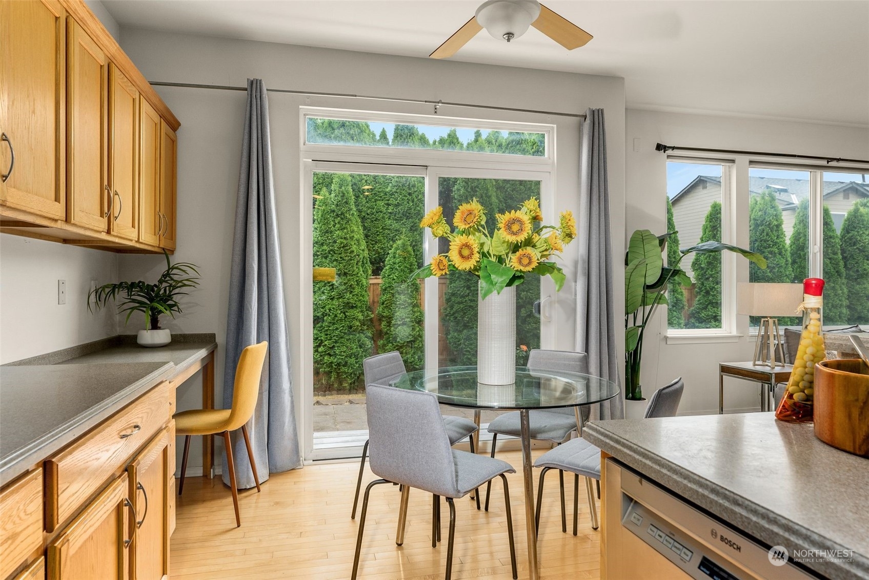 554 Rosario Avenue Northeast Renton, WA 98059 - Photo 12 of 38 a dining room with furniture a potted plant and a large window