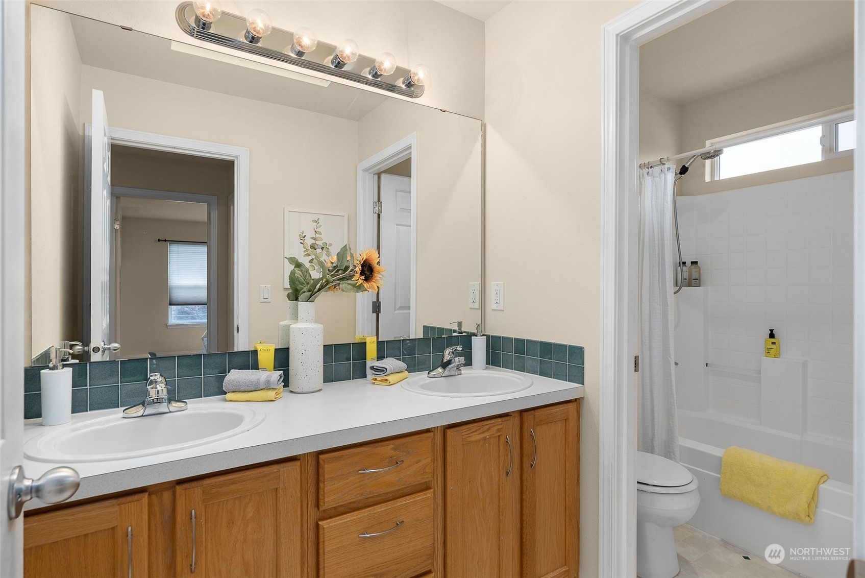 554 Rosario Avenue Northeast Renton, WA 98059 - Photo 25 of 38 a bathroom with a granite countertop sink a toilet a mirror and shower
