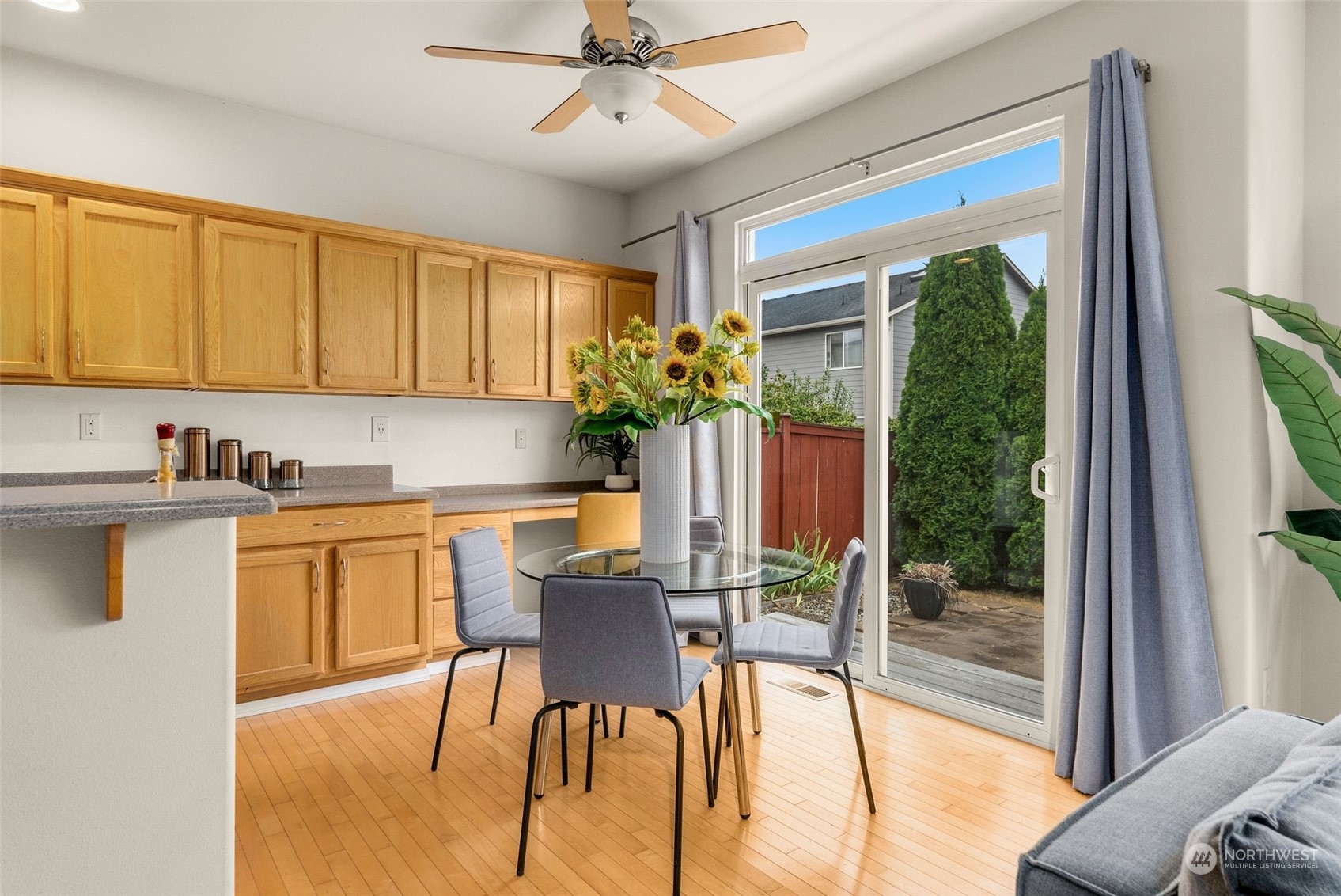 554 Rosario Avenue Northeast Renton, WA 98059 - Photo 8 of 38 a kitchen with a table chairs refrigerator and cabinets