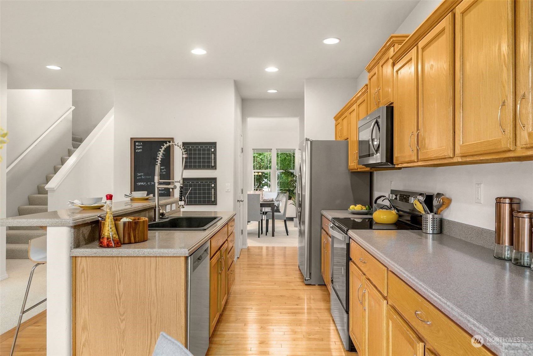 554 Rosario Avenue Northeast Renton, WA 98059 - Photo 10 of 38 a kitchen with counter top space a sink and appliances